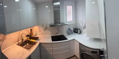 a kitchen with a sink and a washing machine at Apartamento Plaza España - Bordeta BCN in Barcelona