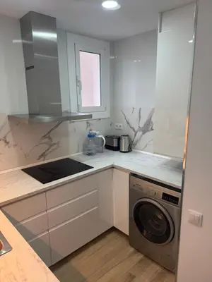 a white kitchen with a washing machine in it at Apartamento Plaza España - Bordeta BCN in Barcelona