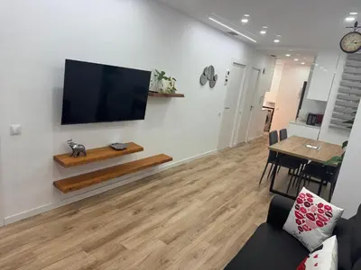 a living room with a flat screen tv on a wall at Apartamento Plaza España - Bordeta BCN in Barcelona
