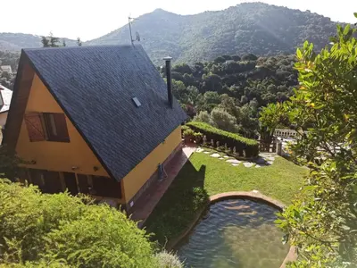 an aerial view of a house with a swimming pool at Villa cascada in Sant Cebrià de Vallalta