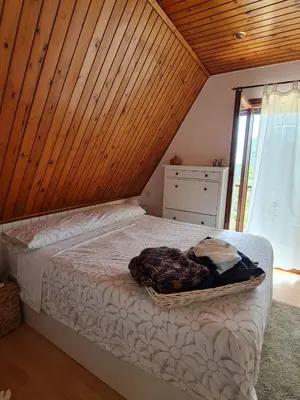a bedroom with a bed with a wooden ceiling at Villa cascada in Sant Cebrià de Vallalta