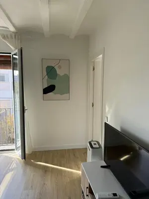 a white room with a desk and a painting on the wall at Unique Ramblas in Barcelona