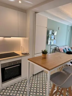 a kitchen with a table and chairs in a room at Unique Ramblas in Barcelona