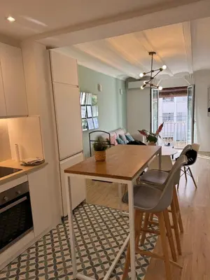 a kitchen and dining room with a table and chairs at Unique Ramblas in Barcelona