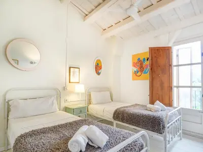 a bedroom with two beds and a window at Masia Las Torres by Hello Homes Sitges in Sitges