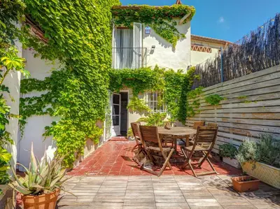 an outdoor patio with a table and chairs at Masia Las Torres by Hello Homes Sitges in Sitges