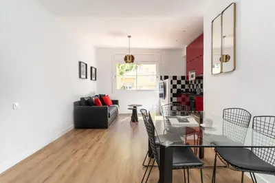 a living room and dining room with a table and chairs at Dúplex Deluxe Apartment in Badalona