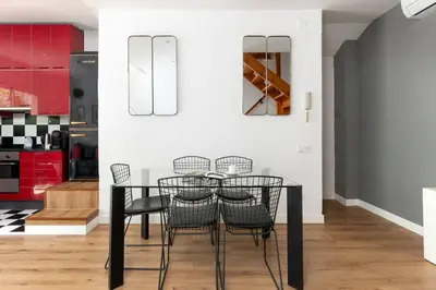 a dining room with a glass table and chairs at Dúplex Deluxe Apartment in Badalona