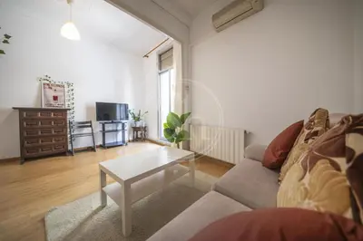 a living room with a couch and a table at Bonito apartamento en Poble Sec in Barcelona