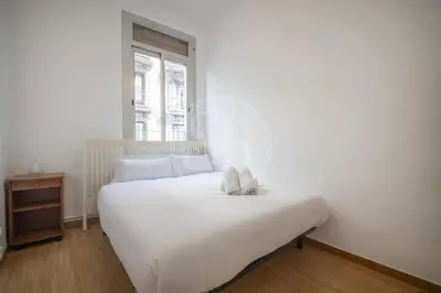 a living room with a couch and a chair at Bonito apartamento en Poble Sec in Barcelona