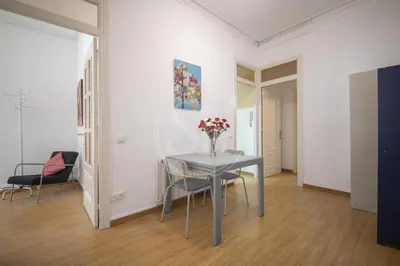 a white bed with two towels on top of it at Bonito apartamento en Poble Sec in Barcelona