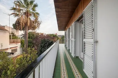 a balcony with green flooring and a white fence at Marina beach Castelldefels in Castelldefels