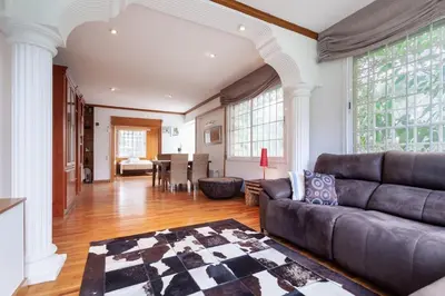 a living room with a couch and a table at Villa Drago in Castelldefels