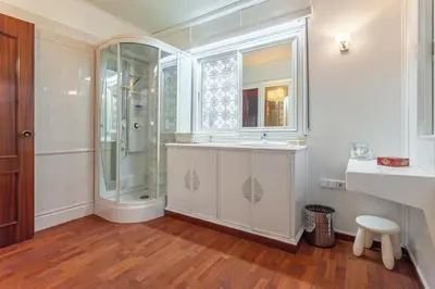 a white bathroom with a shower and a sink at Villa Drago in Castelldefels