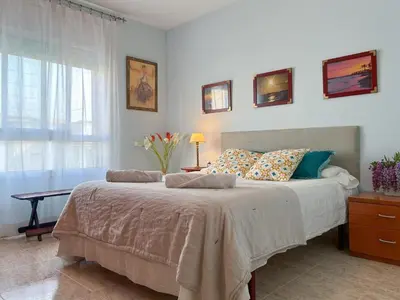 a bedroom with a large bed and a window at Apartment Rivel in Cubelles