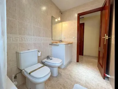 a bathroom with a toilet and a sink and a mirror at Apartment Rivel in Cubelles