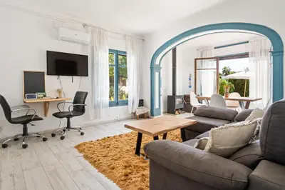 a living room with a couch and a table at Atenea Room by the Beach - Claire Homes in Castelldefels
