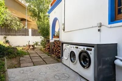 a washing machine sitting next to a building at Atenea Room by the Beach - Claire Homes in Castelldefels