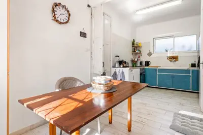 a kitchen with a wooden table in a room at Atenea Room by the Beach - Claire Homes in Castelldefels