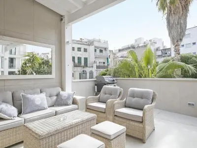 a patio with a couch and chairs on a balcony at Sitges Spaces Urban Beach Flat- 3 Bedrooms, 3 Bathrooms, Huge Terrace, Near Beach in Sitges