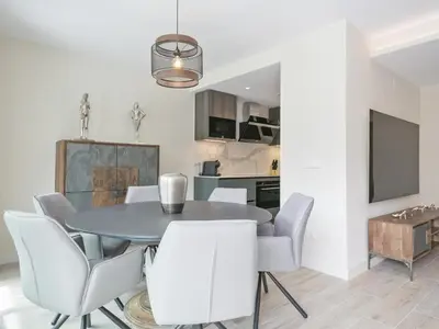 a dining room with a table and white chairs at Sitges Spaces Urban Beach Flat- 3 Bedrooms, 3 Bathrooms, Huge Terrace, Near Beach in Sitges