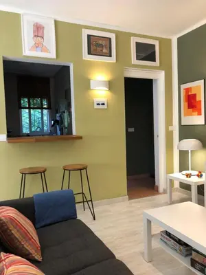 a living room with a couch and stools at Pineda 38 in Gavà
