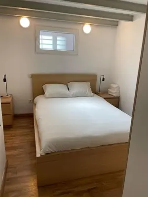 a bedroom with a bed with white sheets and a window at SA 15min downtown Barcelona, 5min Metro, Beach nearby in Sant Adria de Besos