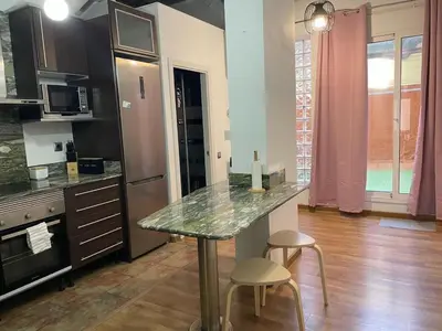 a kitchen with a counter and two stools in it at SA 15min downtown Barcelona, 5min Metro, Beach nearby in Sant Adria de Besos
