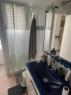 a bathroom with a blue sink and a shower at Room Montjuic in Barcelona