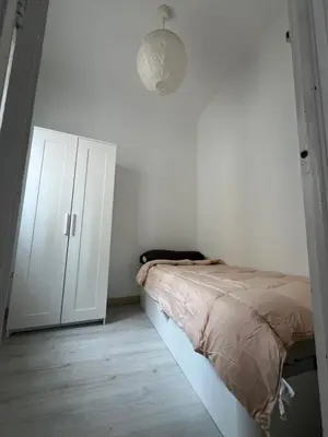 a bedroom with a bed and a white cabinet at Room Montjuic in Barcelona