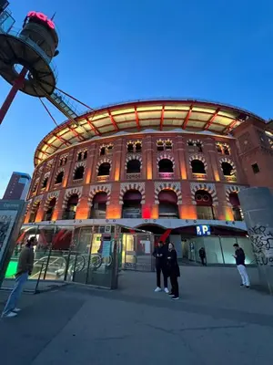 a group of people standing in front of a large building at Room Montjuic in Barcelona