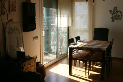 a table and chairs in a room with a window at Alojamiento entero luminoso y bien ubicado en Terrassa Barcelona 3habitaciones 2baños in Terrassa