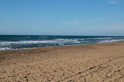 an empty beach with the ocean in the background at Panoramic view Gavà Mar in Gavà