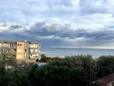 a view of the beach and a building and the ocean at Panoramic view Gavà Mar in Gavà