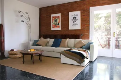 a living room with a couch and a table at VILLA Mar y Montaña in Castelldefels