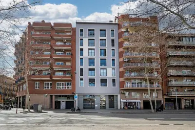 a tall white building next to two tall buildings at CATERINA Bac de Roda in Barcelona