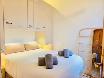 a bedroom with a large white bed with two pillows at Stunning APT WiFi 6 min Sagrada Familia 2BR in Barcelona