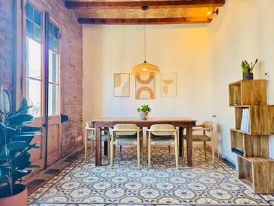 a dining room with a wooden table and chairs at Stunning APT WiFi 6 min Sagrada Familia 2BR in Barcelona