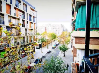 a view of a city street with trees and buildings at Ramblas Rentals Spacious & Design 4Br Flat With Balcony 15m Ramblas in Barcelona