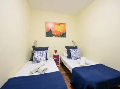 two beds in a room with blue and white at Ramblas Rentals Spacious & Design 4Br Flat With Balcony 15m Ramblas in Barcelona