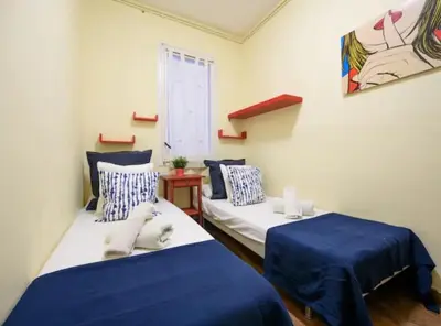 two beds in a room with blue and white at Ramblas Rentals Spacious & Design 4Br Flat With Balcony 15m Ramblas in Barcelona