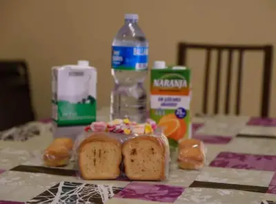 a table with a loaf of bread and a bottle of water at Ramblas Rentals Unique & Spacious Flat 4BR Terrace 20M Ramblas in Barcelona