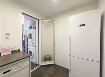 a kitchen with a refrigerator and a washer and dryer at Ramblas Rentals Unique & Spacious Flat 4BR Terrace 20M Ramblas in Barcelona