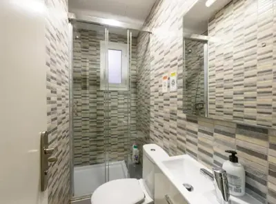 a bathroom with a toilet and a sink and a shower at Ramblas Rentals Unique & Spacious Flat 4BR Terrace 20M Ramblas in Barcelona