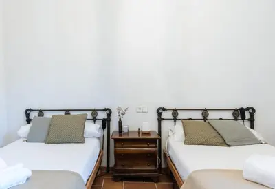 a bedroom with two beds and a nightstand at El Mirador Esencia Mediterránea in Arenys de Mar