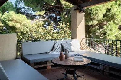 a patio with a couch and a table at El Mirador Esencia Mediterránea in Arenys de Mar