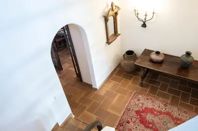 a hallway with a table and some vases on the floor at El Mirador Esencia Mediterránea in Arenys de Mar