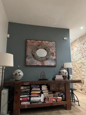 a living room with a table with books at Rustic Casita Gavà in Barcelona
