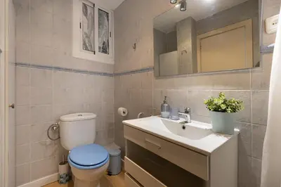 a bathroom with a toilet and a sink at Bright Apartment In Gava Mar in Gavà