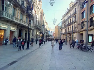 a group of people walking down a city street at Central Azulete in Barcelona